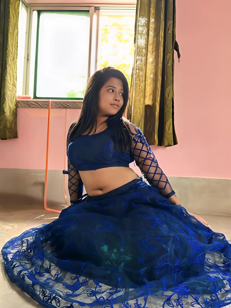 Friendly Escort Riya posing outdoors in a stylish outfit